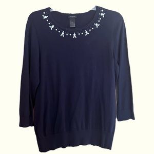 Navy and white beadwork around neck.